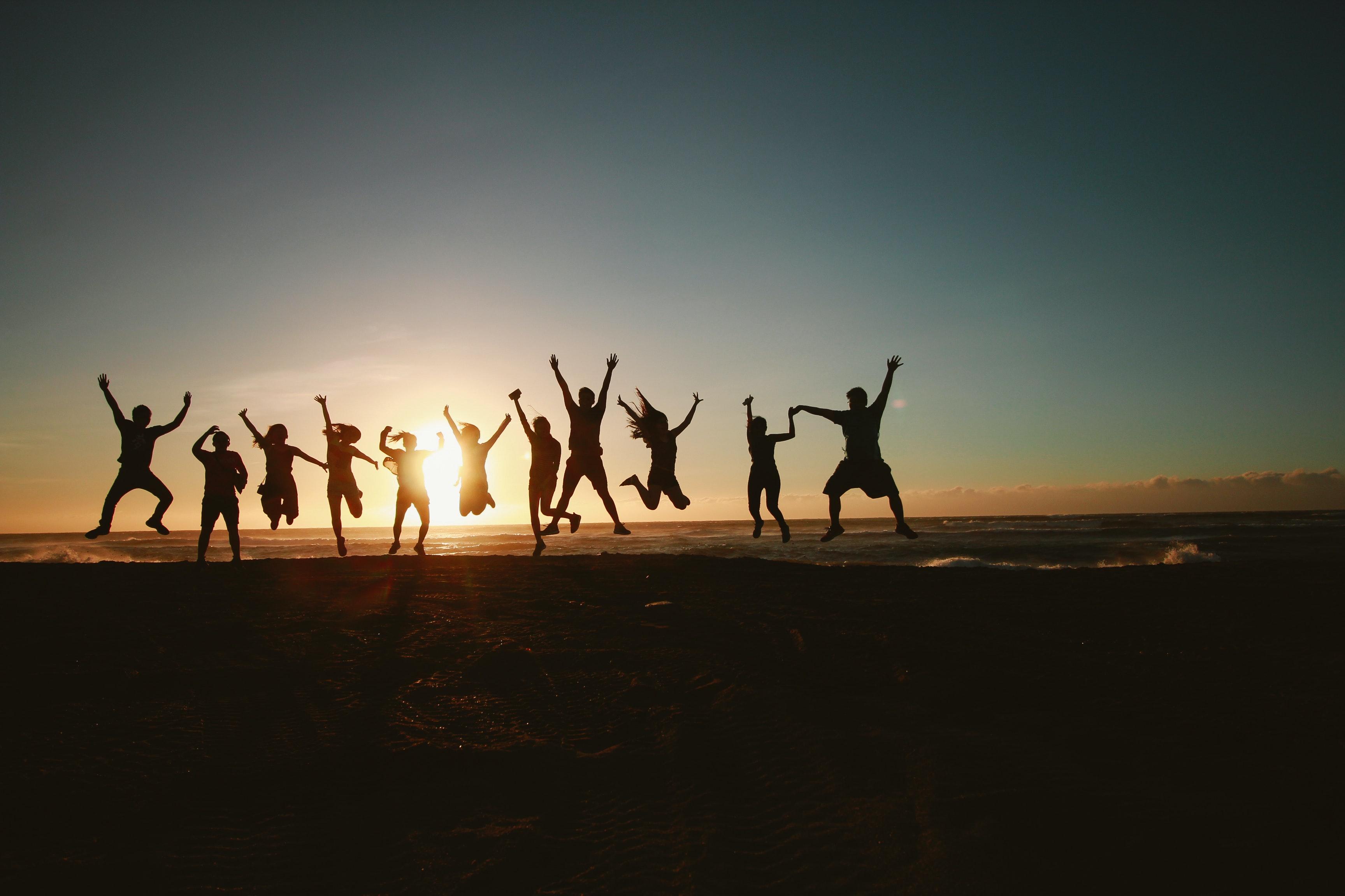 people jumping at sunset